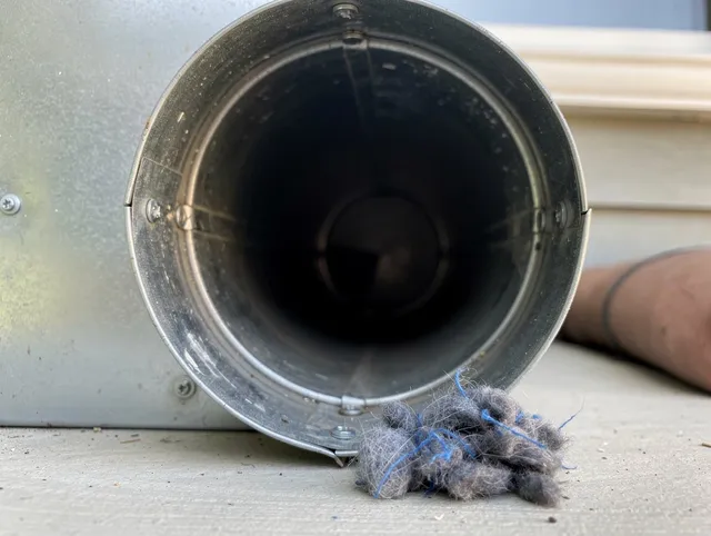 New Milford Dryer Vent Cleaning technician using specialized equipment to clear severe dryer vent blockage in New Milford